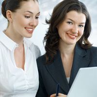 Two business women holding laptop
